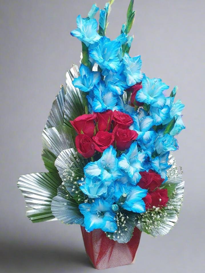 Discover the beauty of red roses and gladiolus in sky blue. A perfect floral combination symbolizing love and tranquility, ideal for any occasion.