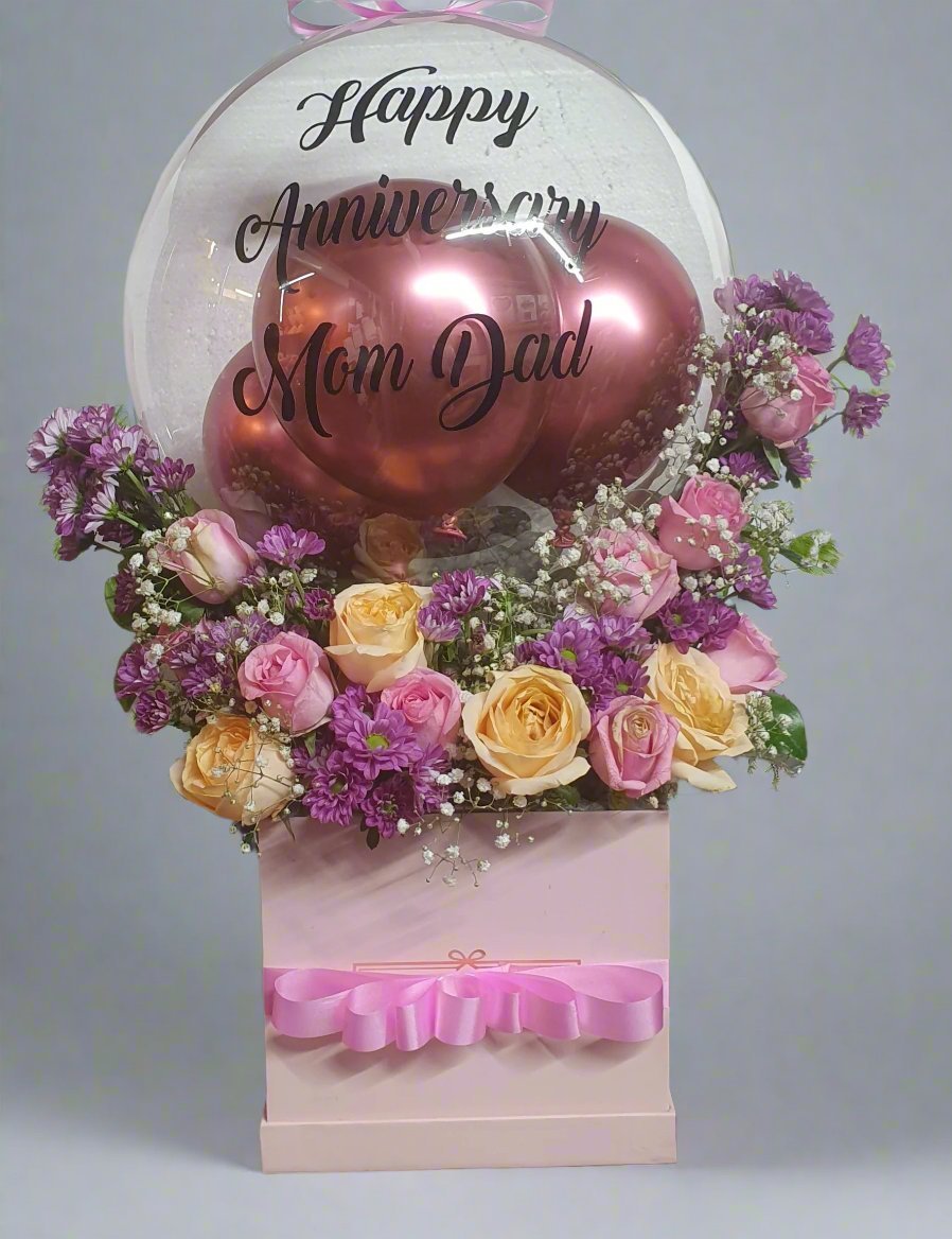 Send the perfect birthday surprise with a beautiful gift box of yellow-pink roses, purple daisies, and stylish "Happy Birthday" balloons. A delightful combination to brighten someone's special day.