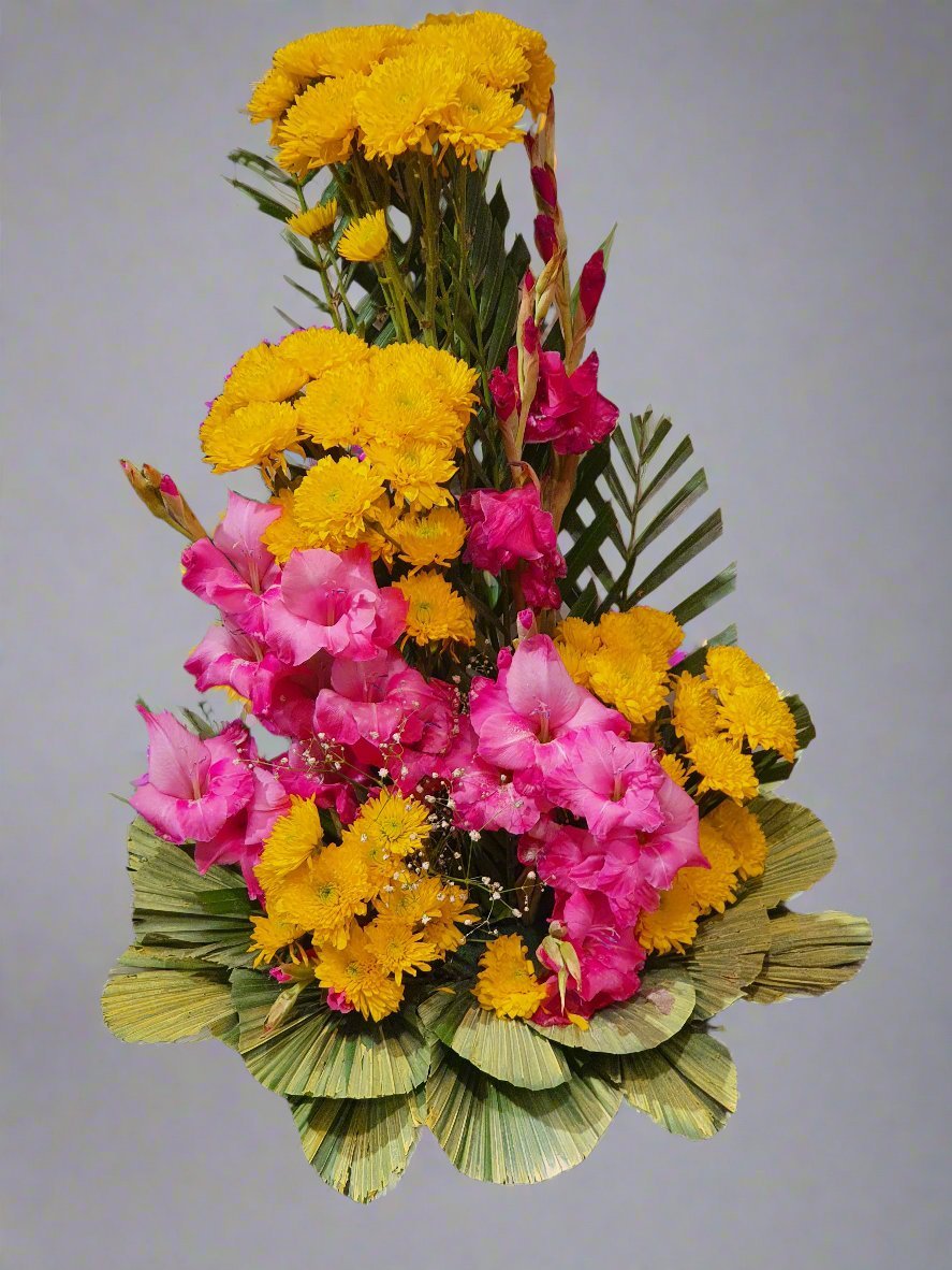 Discover the radiant beauty of yellow and pink lilies paired with lush ricabum. A stunning blend of vibrant hues and elegant textures.