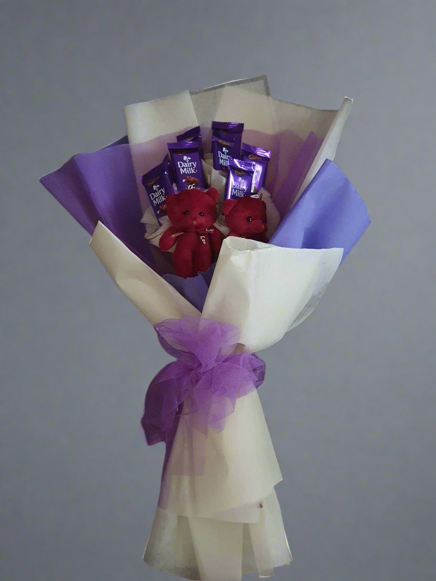 A beautiful bouquet with white and purple bouqute Dairy Milk chocolates, and two cute red teddy bears. The perfect gift for any occasion.