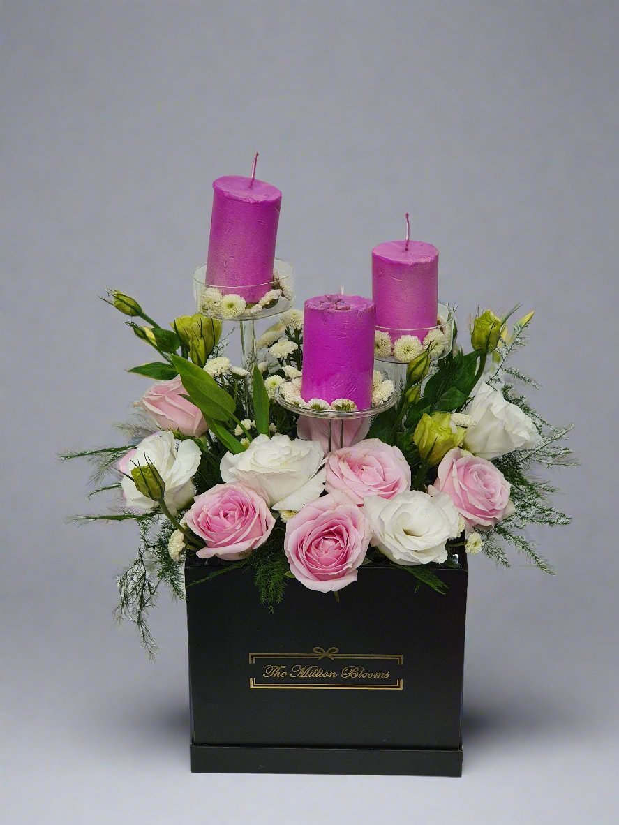 Elegant floral box with pink and white roses, fresh greens, and pink candles—perfect for celebrations or as a centerpiece for any special occasion.