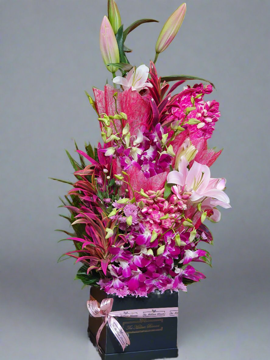 Elegant floral arrangement featuring vibrant pink orchids and lilies, perfect for adding a touch of beauty and sophistication to any space.