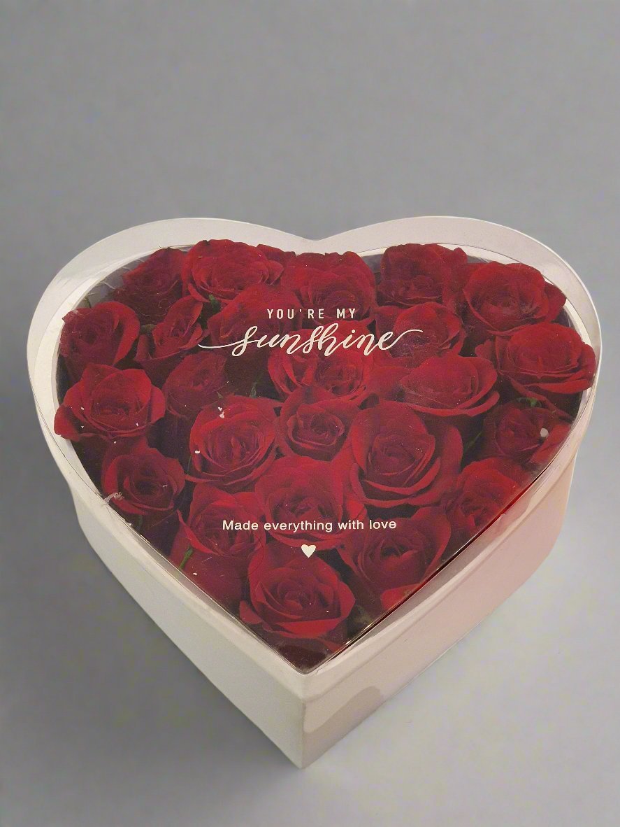 A heart-shaped box of vibrant red roses, elegantly arranged to symbolize love and passion, perfect for romantic occasions or heartfelt surprises.