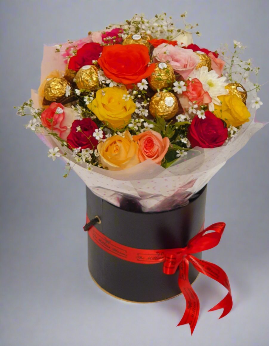 Elegant black box with red ribbon, featuring mixed roses and Ferrero Rocher chocolates, perfect for a thoughtful gift.