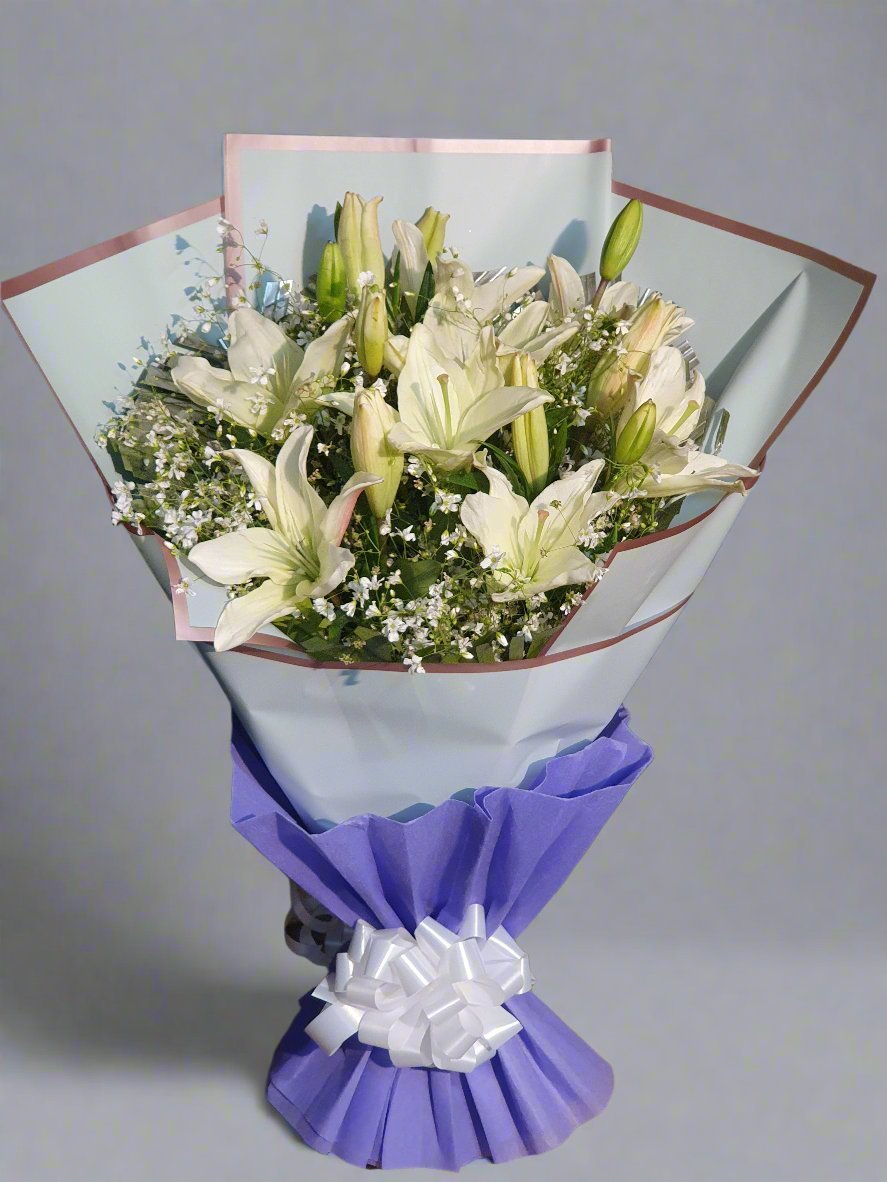 A beautiful bouquet of white lilies with green fillers perfect for elegant gifts and special occasions. Pure, fresh, and sophisticated.