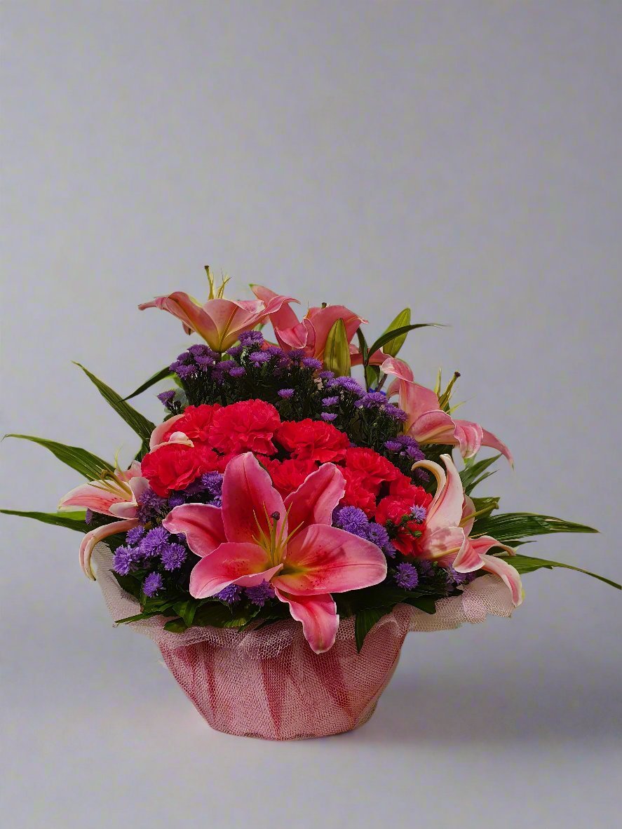 A luxurious bouquet featuring red roses, purple carnations, and pink lilies. A perfect blend of passion, elegance, and timeless beauty.