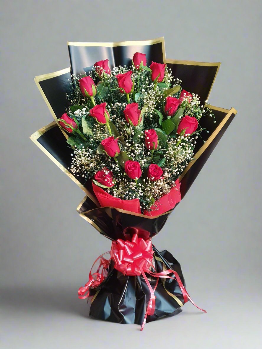 Luxurious bouquet with 15 red roses, white-green fillers, and elegant black wrapping with golden stripes. Perfect for any special moment.