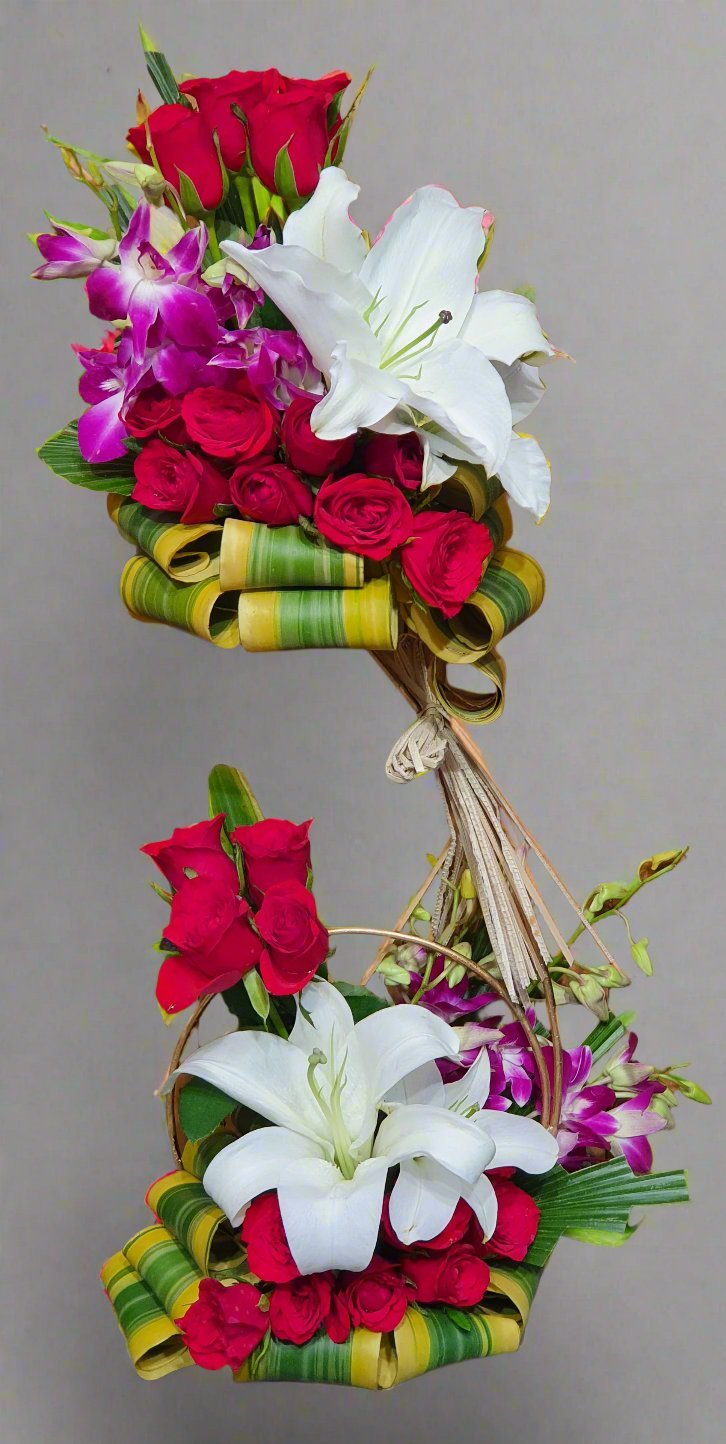 Discover the enchanting beauty of red and purple roses combined with elegant white lilies in this stunning floral arrangement. Perfect for any occasion.