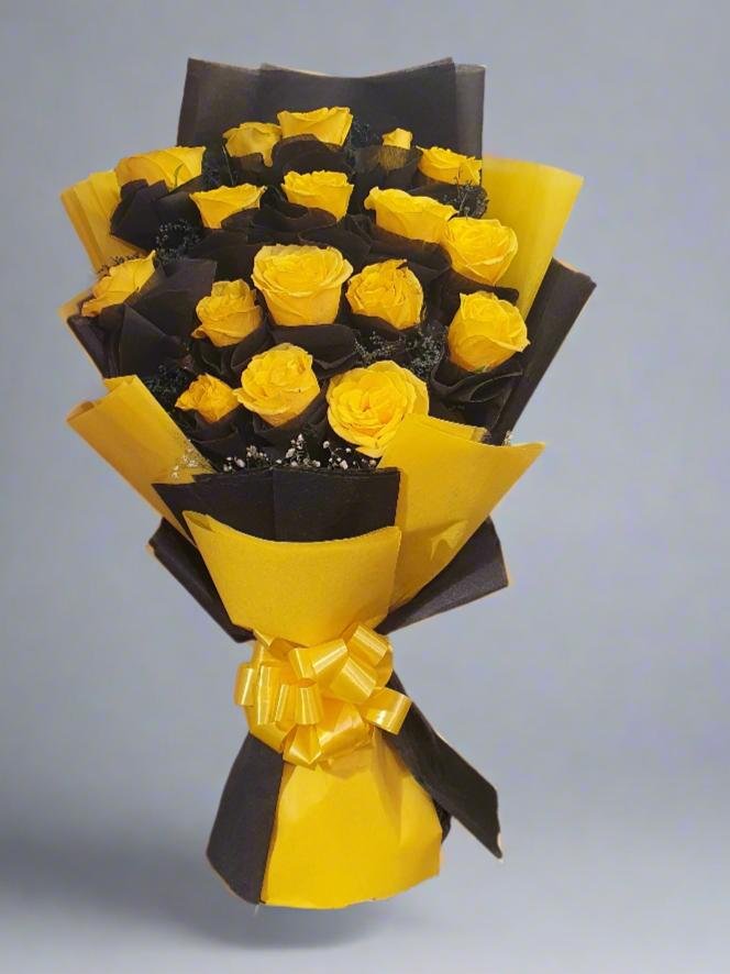 Discover a stunning yellow rose bouquet paired with black accents, perfect for gifting or decor. Vibrance meets sophistication in this unique arrangement.