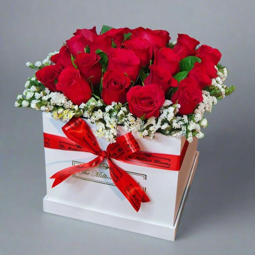 Elegant red roses in a white box with fresh white and green fillers, perfect for any special occasion. A beautiful display of love and sophistication.