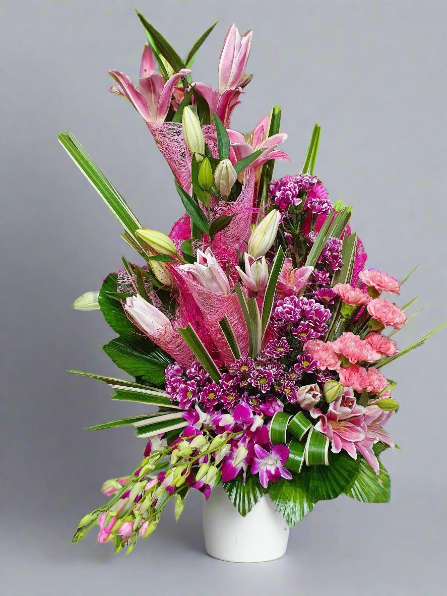 A serene blend of pink carnations and white lilies, symbolizing love and purity. Perfect for weddings, gifts, or special occasions.