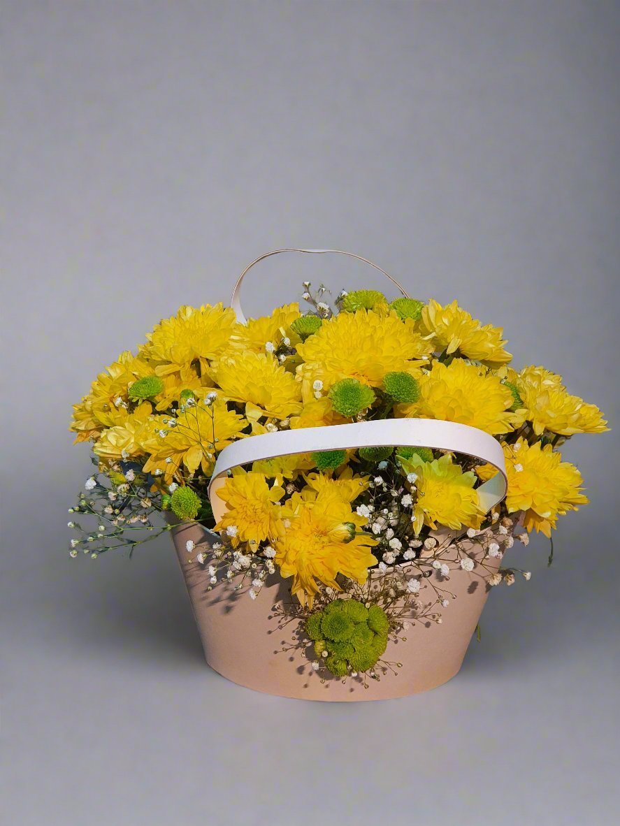 Yellow carnations in a basket bring warmth, joy, and elegance to any space. A perfect choice for celebrations and cheerful gifting.