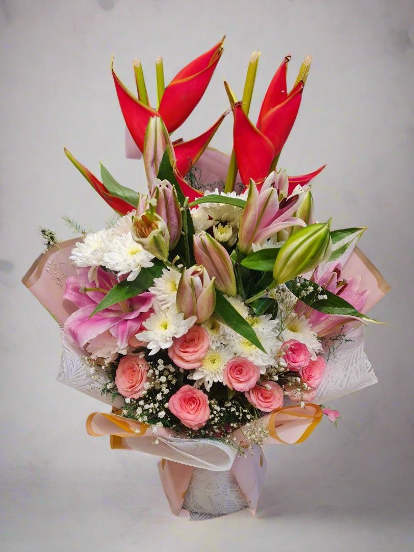 Stunning bouquet with vibrant bird of paradise, pink roses, white daisies, and pink lilies. Perfect for gifting or home decor. Order now!