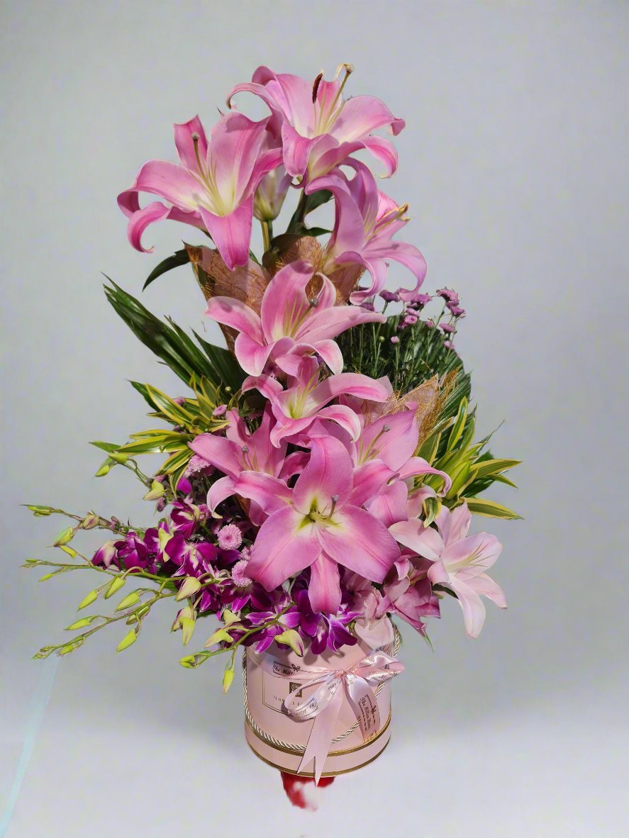 Discover a stunning bouquet of vibrant pink lilies and delicate pink orchids, perfect for any occasion. Elegance meets timeless beauty!