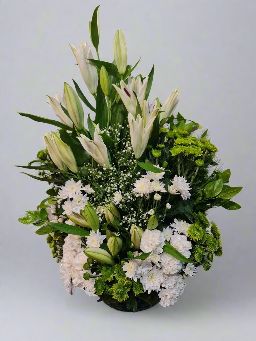 Elegant floral arrangement featuring white carnations, lilies, and green daisies. Perfect for any occasion. Order now for fresh, vibrant flowers!