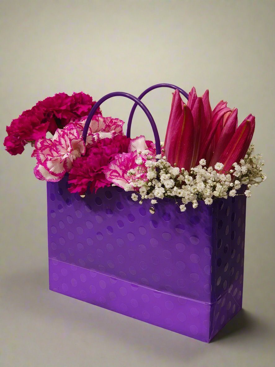 Elegant floral arrangement featuring vibrant pink carnations and lilies, perfect for adding charm to any occasion. Fresh, beautiful, and lasting.