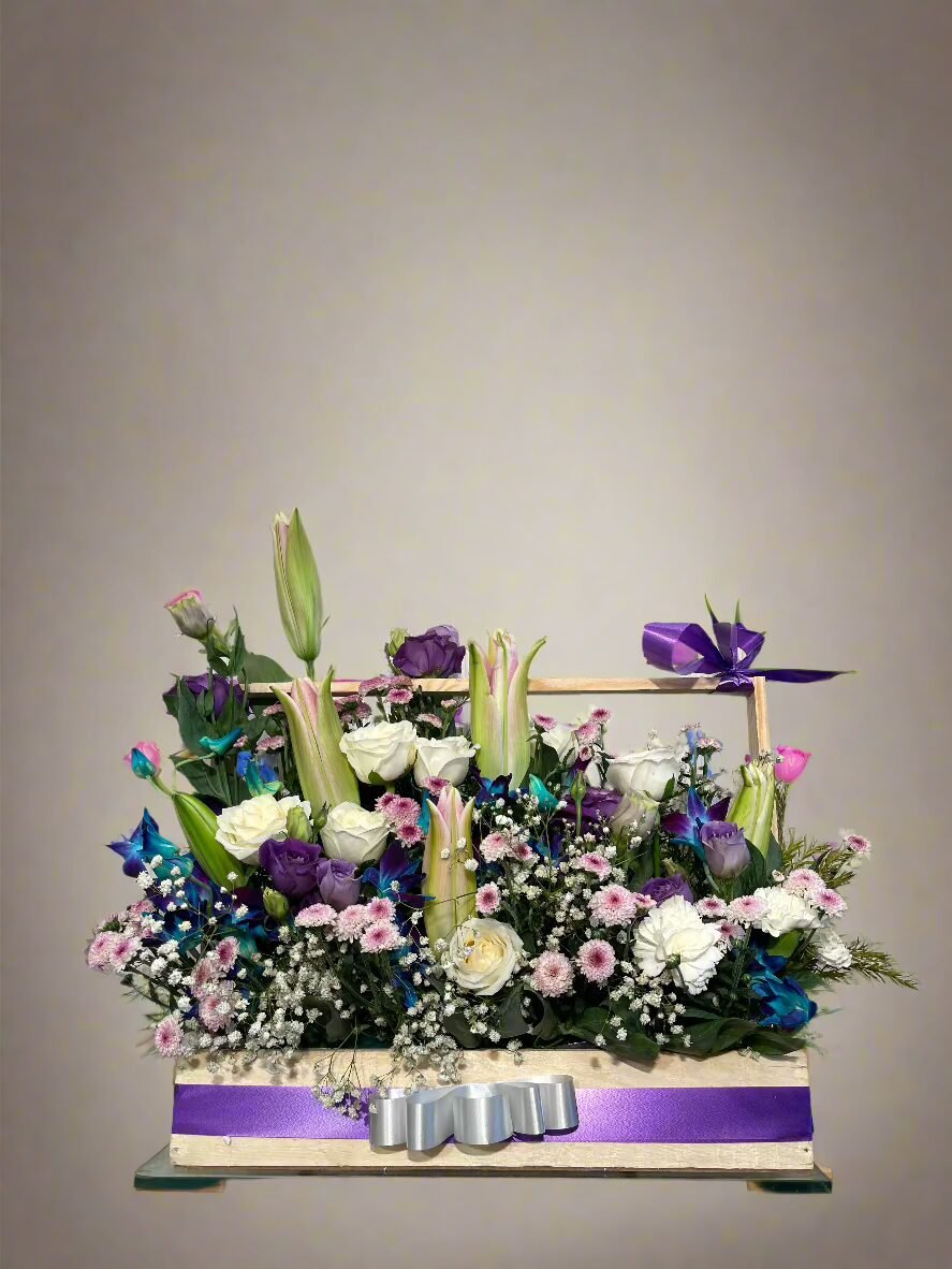 Discover a stunning floral arrangement with white and purple roses, pink daisies, and exotic orchids, blending beauty and elegance in perfect harmony.