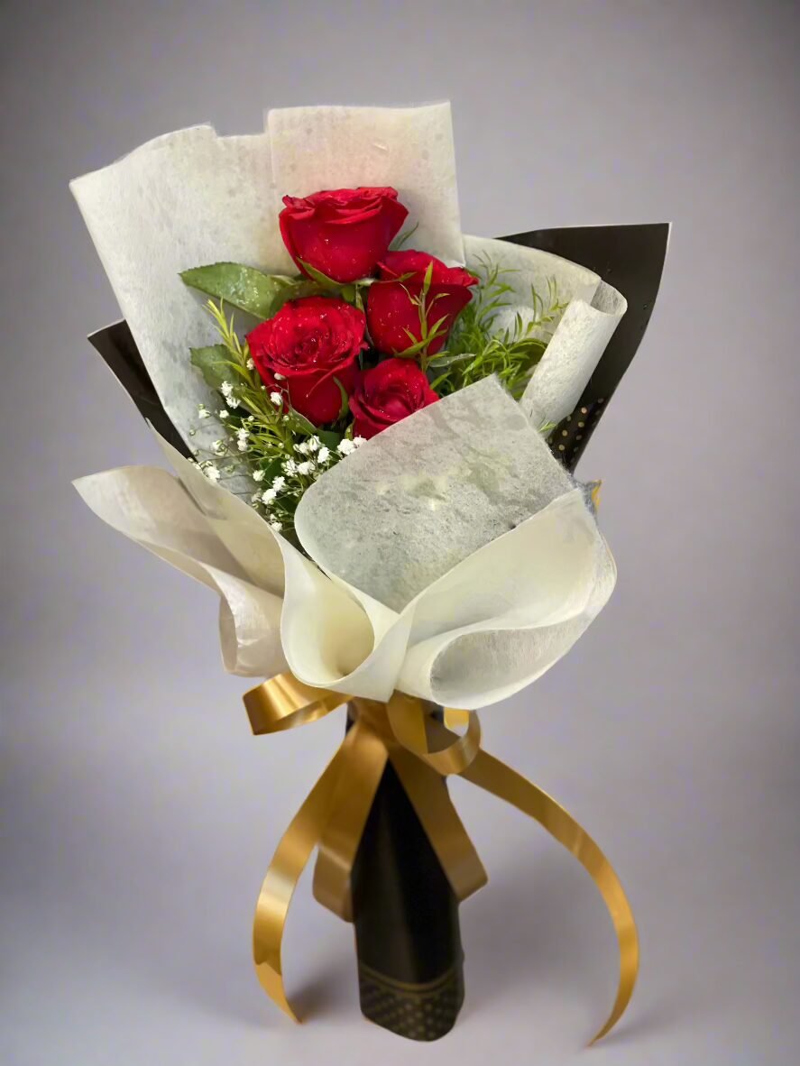 "Elegant red roses wrapped in white paper with green leaves. Perfect for romantic occasions, anniversaries, or heartfelt gifts. Order online today