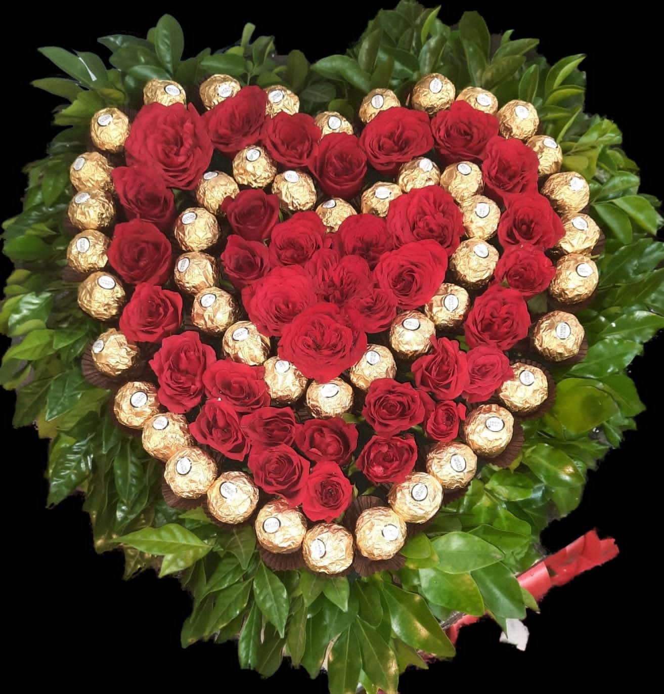 Send love with red roses inside a heart-shaped Ferrero Rocher box, bordered with green leaves. Perfect gift for any romantic occasion.