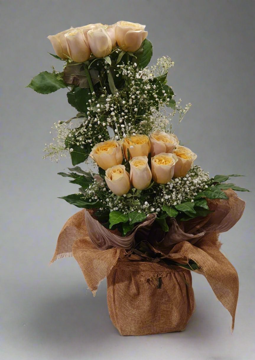 Brighten your space with yellow flowers, white accents, and lush green leaves. Perfect for adding elegance and cheer to any occasion. Shop now!