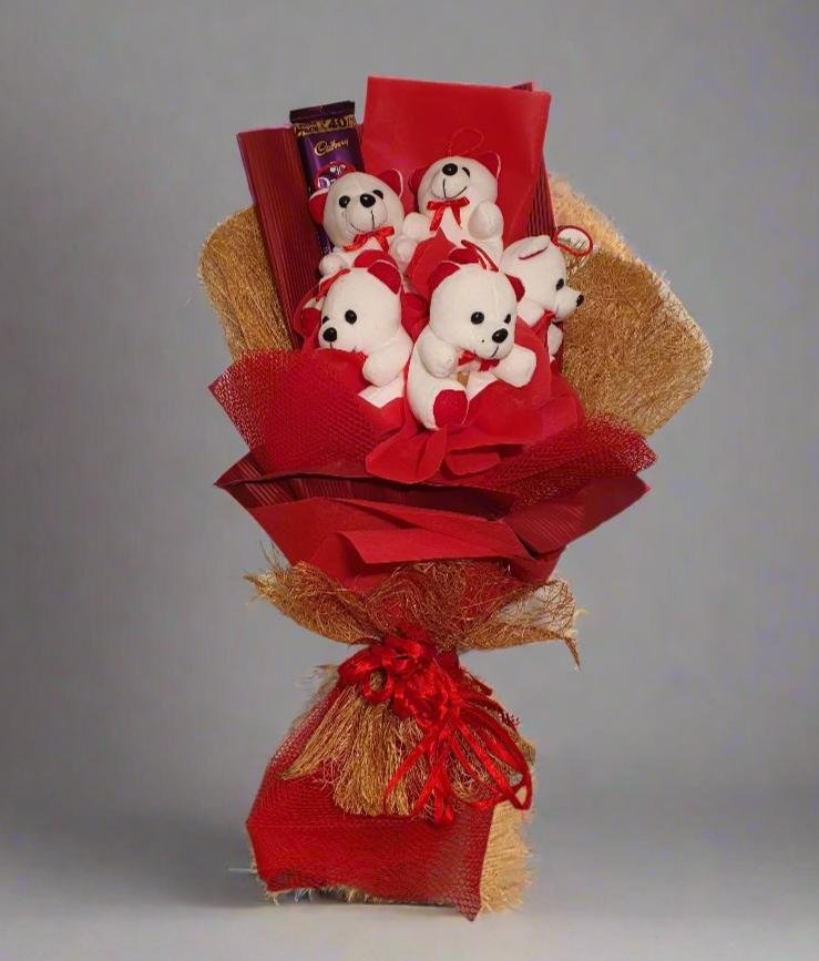 Delightful teddy bear bouquet with cuddly white bears, red ribbons, & Dairy Milk chocolate. Perfect gift for loved ones! Shop now for sweet surprises!