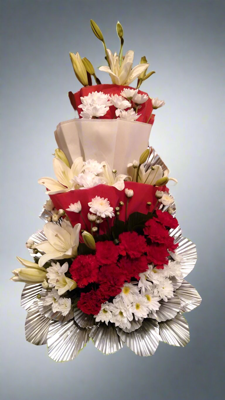 Celebrate life's special moments with a vibrant mix of red carnations, white lilies, and daisies. Expertly crafted for bold beauty and serene elegance.